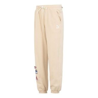 Pantalones deportivos con insignia del equipo en color beige