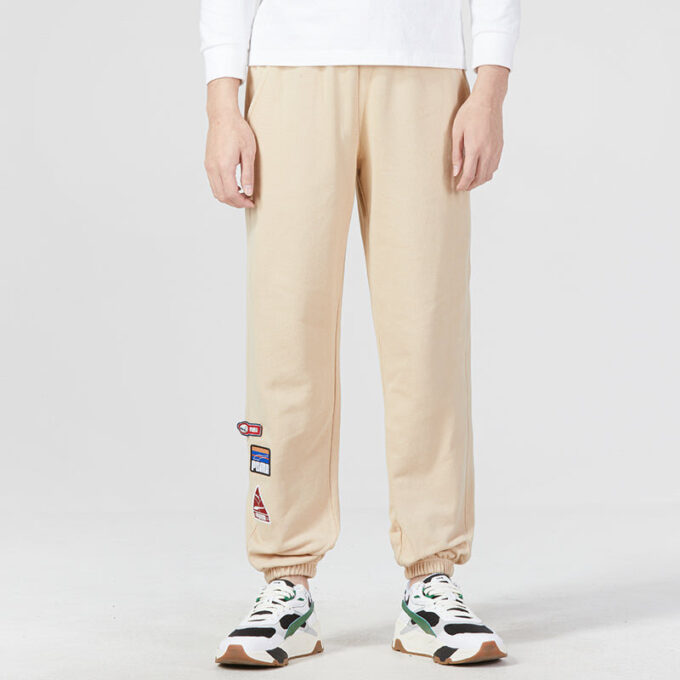 Pantalones deportivos con insignia del equipo en color beige