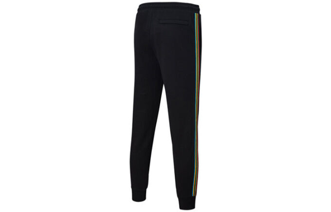 Pantalones deportivos Unity de Tailored For Sport “Negro Naranja”