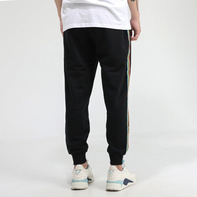 Pantalones deportivos Unity de Tailored For Sport “Negro Naranja”