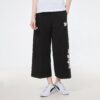 (WMNS) Pantalones casuales de punto con estampado de logotipo en negro